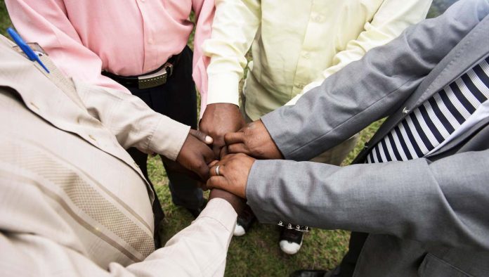 black professional men holding hands-World Relief website