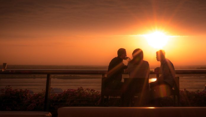 friends group talking at sunset-cc-Heath Cajandig