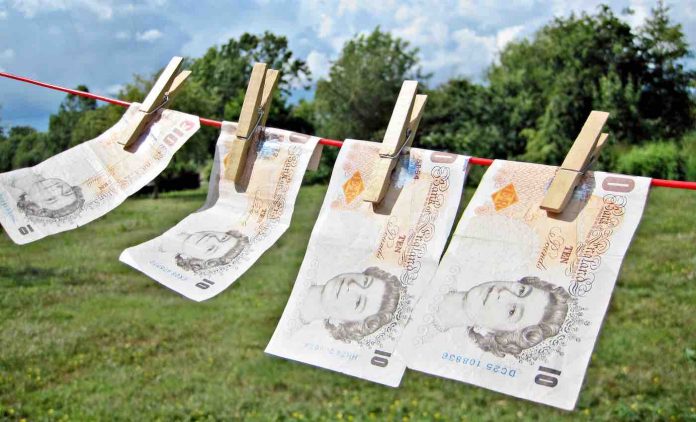 English Pounds of Cash Hanging From Outside Laundry Line-CC TaxRebate.org w: link via Flickr