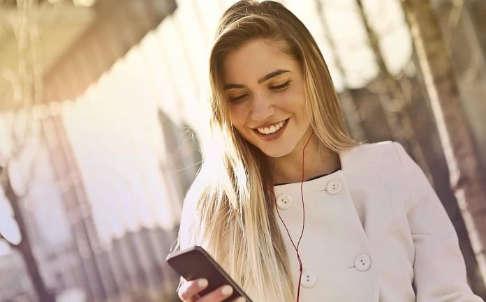 Smiling Woman Using Cell Phone-Public Domain via PXfuel