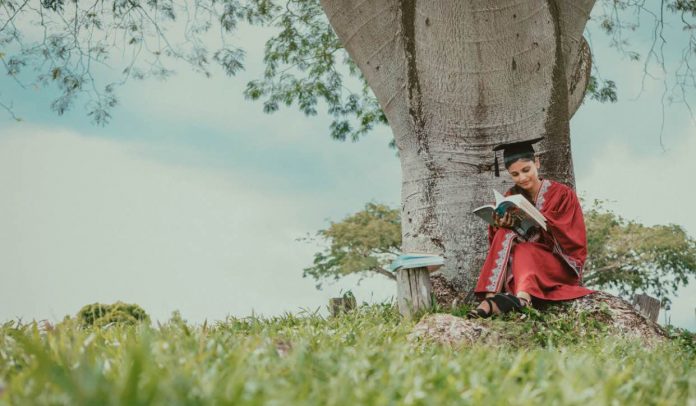 graduate reading under tree nature-pubdomain-Deva Darshan