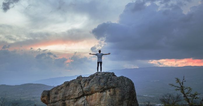 man on cliff victory-gratitude-Colombia-pubdomain-Joshua Earle