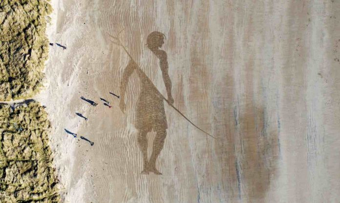Beach Surfer Picture in Sand Feature-SWNS