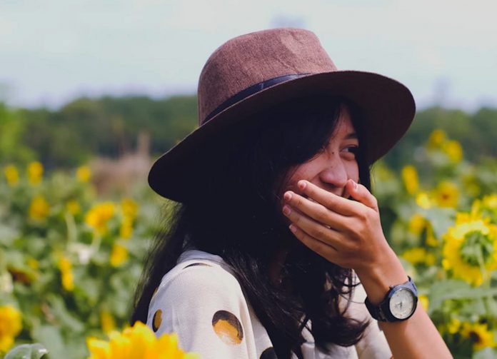 girl laughs sunflowers youth-joke-pubdomain
