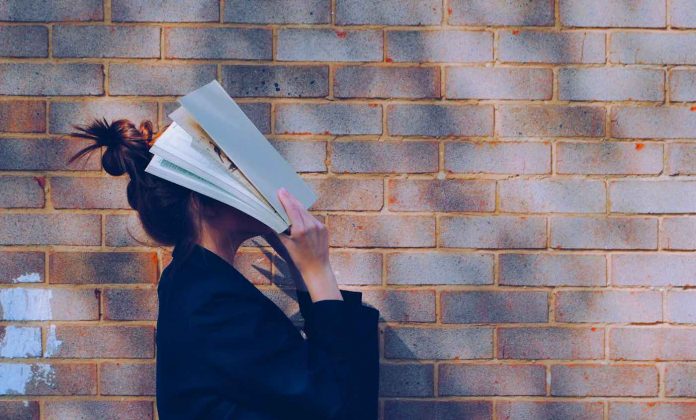 book covering face of school girl frustrated-pubdomain-Siora Photography