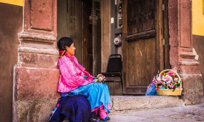 indiginous mexican woman selling dolls colorful-pubdomain-Bernardo Ramonfaur