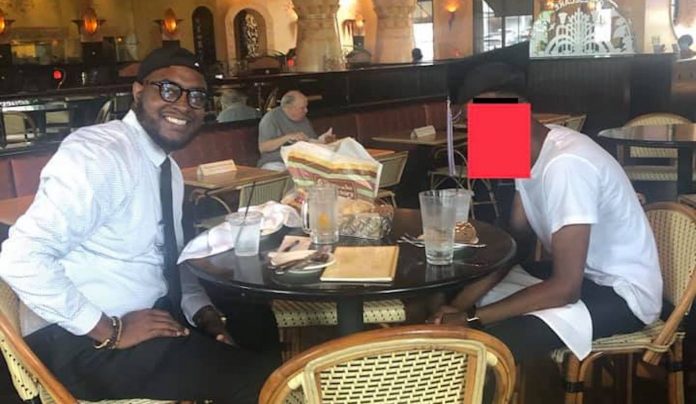Dom Moore with students face covered-FB