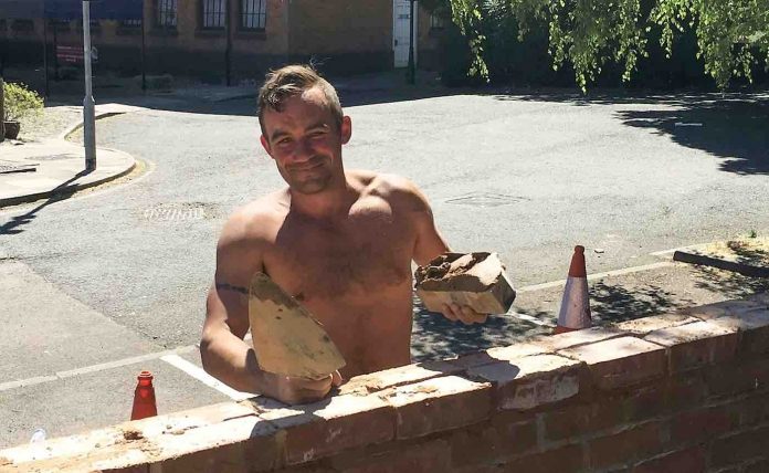 Homeless Man Laying Bricks-SWNS
