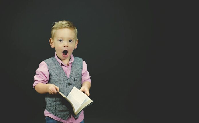 education-boy in awe amazed by book learning-pubdomain-Ben White