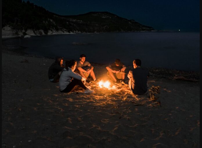 friends-campfire-on-Greece-beach-pubdomain-Tanner Larson