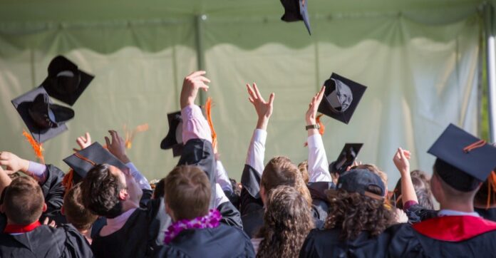 graduates graduation throwing hats pexels-emily-ranquist-public domain