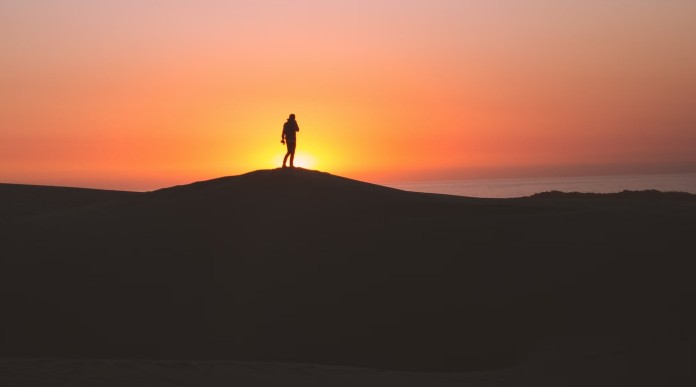 solitary walk at sunset-pubdomain Elijah Hiett