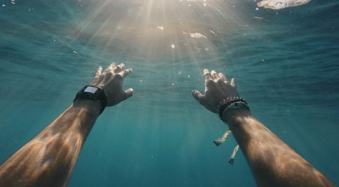 under water hands help reaching-pubdomain Cristian Palmer
