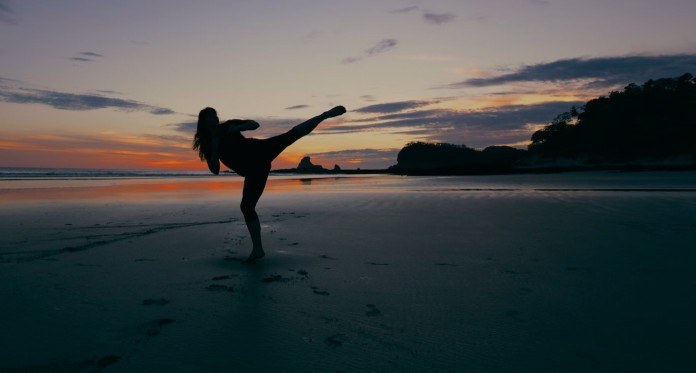 woman karate kick opposing fight on beach-pubdomain Jason Briscoe