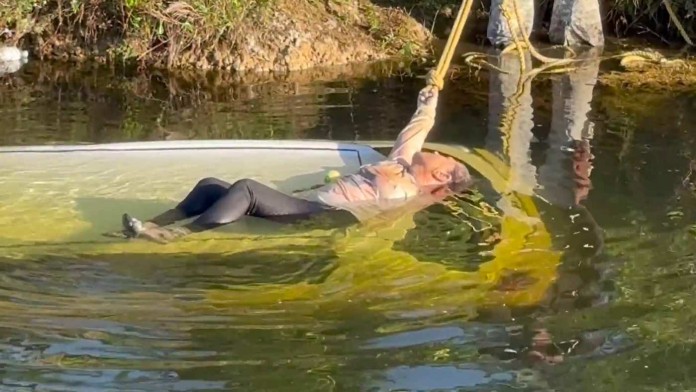 woman rescued by motor paraglider-SWNS