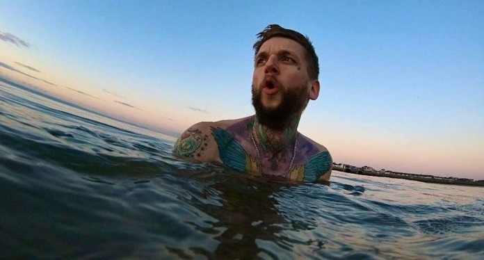 Mitchell Bock swims in cold water-SWNS