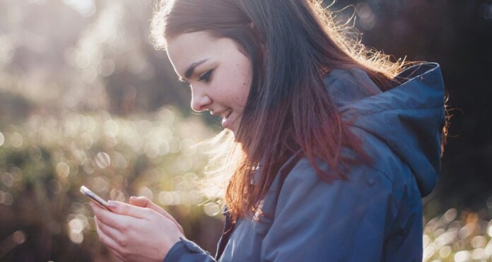 teen girl on phone- by Luke-Porter