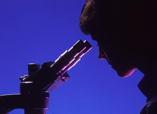 woman scientist microscope research lab test-pubdomain National Cancer Institute