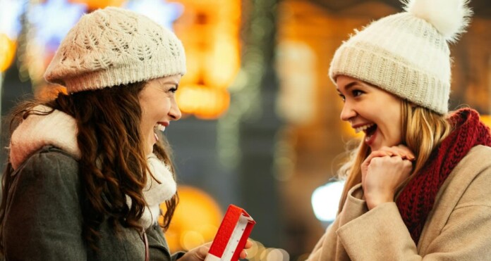 Girlfriends sisters gift giving surprise winter holiday party Getty Images For Unsplash+ OmMnnMXcYhI