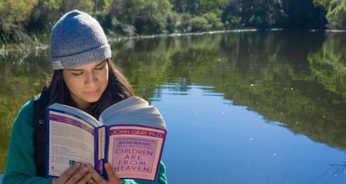 woman reading John Gray book in nature learning Elmer Cañas k-LyLC1QroQ-unsplash