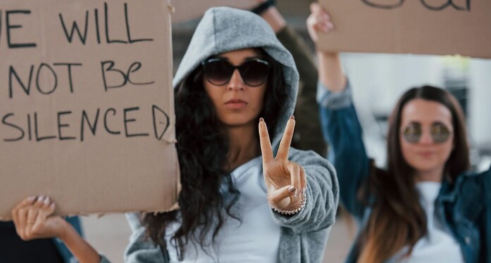 Women protesting freedom speech peace signs Getty Images for Unsplash+ tIK43pssSJA