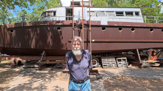 Dale, 86, with the boat he built by hand - credit, Laurence Benson